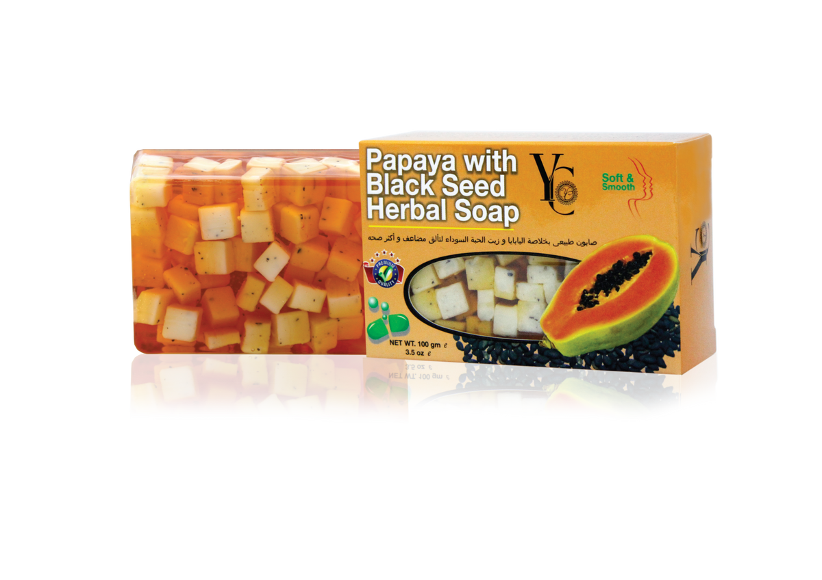 A rectangular bar of Papaya with Black Seed Herbal Soap by Soft & Clean, shown in front of its orange cardboard packaging box on a white background with a reflection.